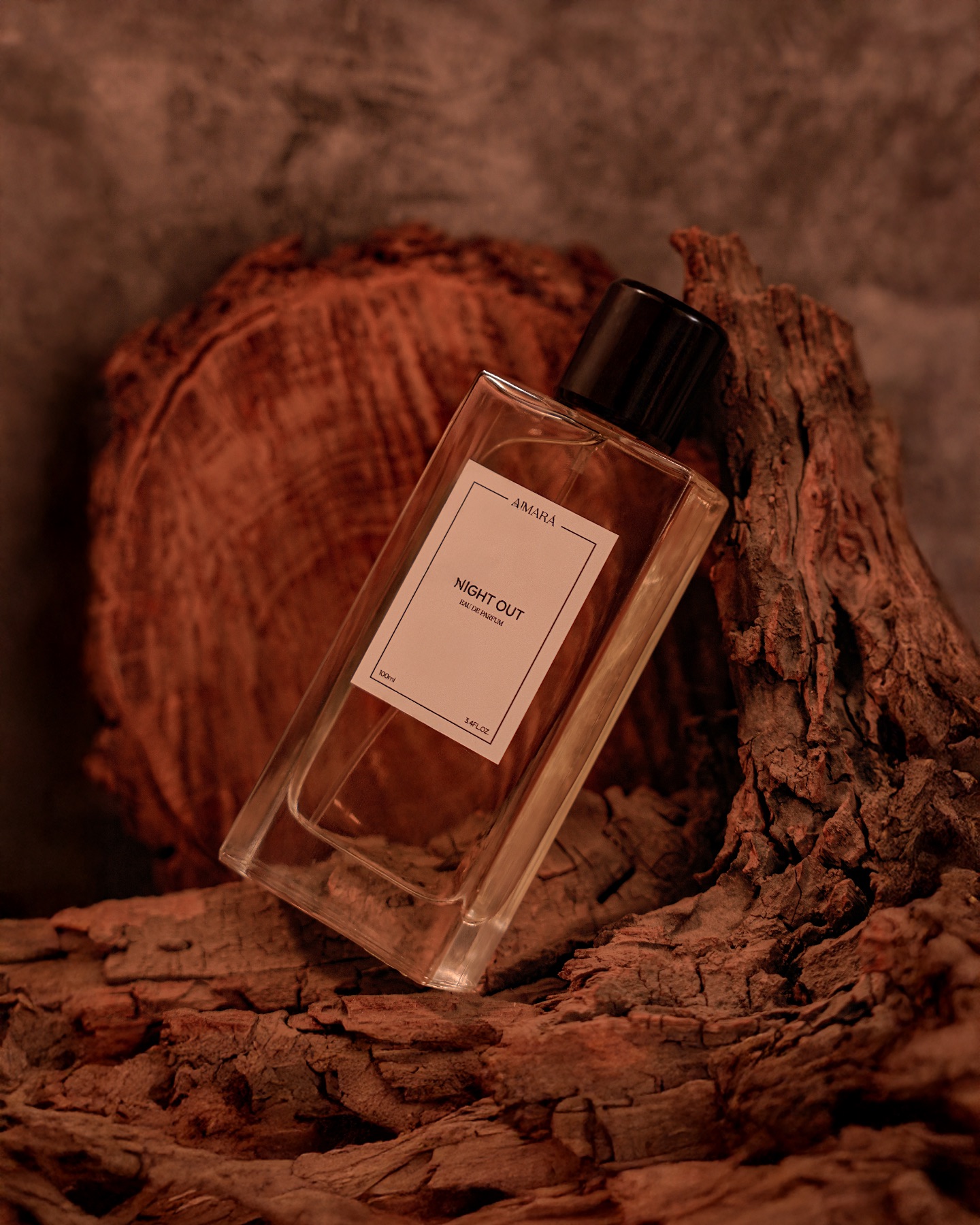Luxury perfume bottle styled in a warm brown textured setting for fragrance product photography.